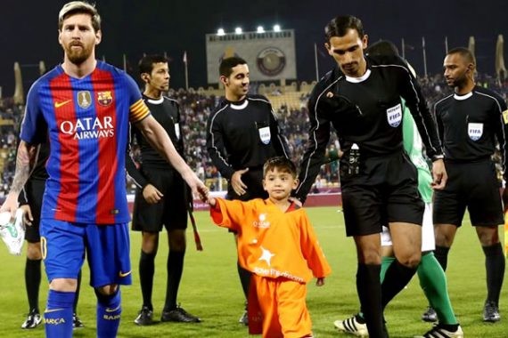 Boy from Afghanistan walks in the stadium with Messi